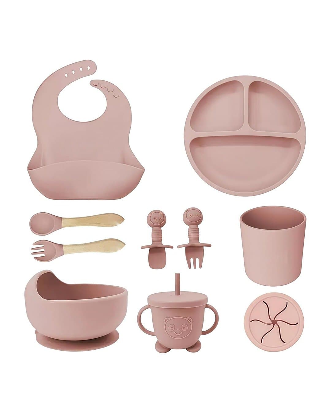 Les 9 pièces du set repas bébé en silicone rose : bavoir, assiette, couverts, gobelet, bol, gobelet à paille et couvercle